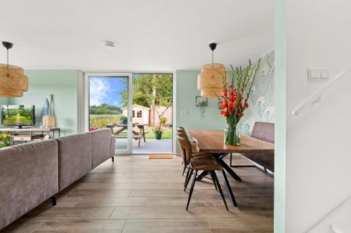 a dining room with a table and chairs at Beach & Forest Retreat -Domburg- in Oostkapelle