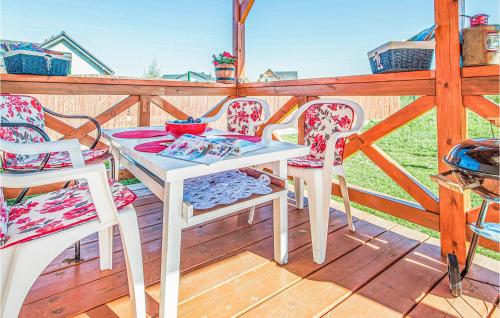 a white table and chairs on a wooden deck at Nice Home In Ustka-Przewloka With Wifi in Ustka