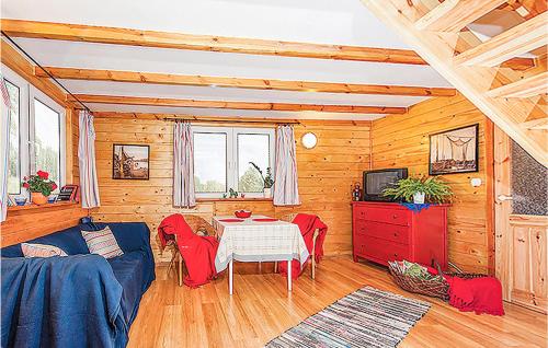 a living room with a blue couch and a table at Nice Home In Ustka-Przewloka With Wifi in Ustka