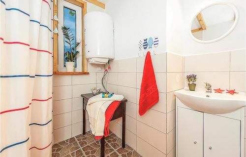 a small bathroom with a sink and a mirror at Lovely Home In Ustka-przewloka With Kitchenette in Ustka