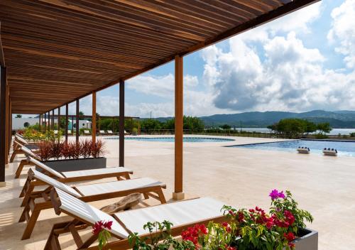 a patio with benches and a swimming pool at Marina Puerto Velero in Tubará