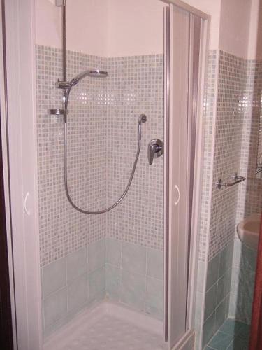 a shower with a glass door in a bathroom at B&B Stella Maris in Diamante