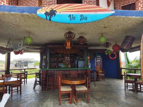 a surfboard hanging over a bar in a restaurant at Un Dia Boutique Resort in Playas