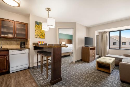 a hotel room with a kitchen and a living room at Staybridge Suites Oklahoma City-Quail Springs by IHG in Oklahoma City
