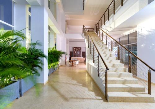a hallway of a building with stairs and plants at Marina Puerto Velero in Tubará