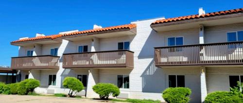 a large white building with balconies on it at Hotel Inn Santa Fe in Santa Fe