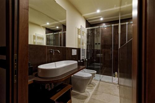 a bathroom with a sink and a toilet and a shower at Gradenigo Apartments 767 in Venice