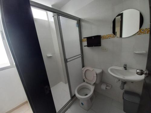 a bathroom with a shower and a toilet and a sink at Villalba Boutique Hotel in Valledupar