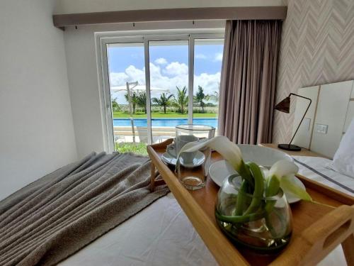 a bedroom with a bed with a view of the ocean at Spectacular Apto Pool Golf View in Hard Rock Golf in Punta Cana