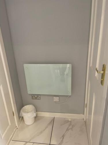 a bathroom with a mirror and a trash can at The Mews in Erith