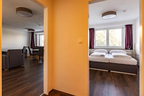 a bedroom with a bed and a window in a room at Hotel Garni VŠB TUO in Ostrava