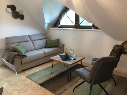 a living room with a couch and a table at Klopeinerperle in Peratschitzen