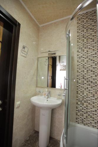 a bathroom with a sink and a shower at Apartment with Summer Terrace in Batumi