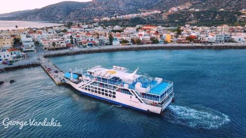 a cruise ship in the water near a city at Haris Studios in Palaiochóra