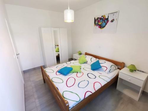 a bedroom with a large bed with colorful pillows at Apartments with parking space Pakostane, Biograd - 18979 in Pakoštane