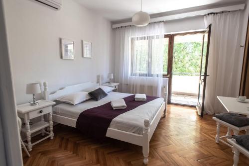 a bedroom with a bed and a large window at Apartments with a parking space Pakostane, Biograd - 18981 in Pakoštane