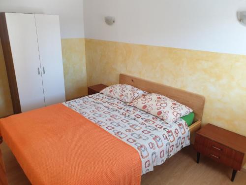 a small bedroom with a bed and a cabinet at Apartments by the sea Tkon, Pasman - 19024 in Tkon