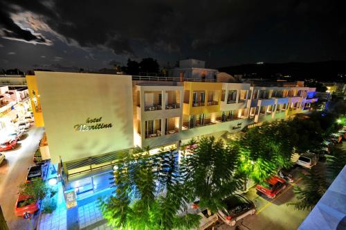 a building with a sign on the side of it at night at Maritina Hotel in Kos Town