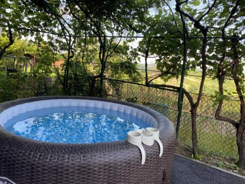 a hot tub in a wicker basket with two white candles at Family friendly house with a parking space Donja Stubica, Zagorje - 19236 in Donja Stubica