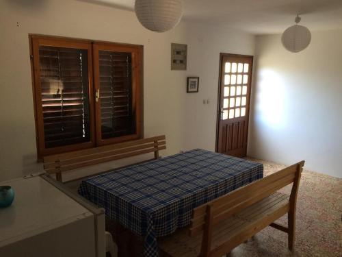 a bedroom with a bed and a bench and a window at Secluded fisherman's cottage Zman, Dugi otok - 19000 in Žman