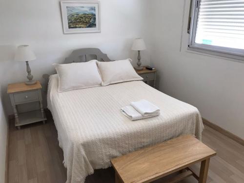 a bedroom with a bed with two towels on it at Mirador San Francisco in Salta