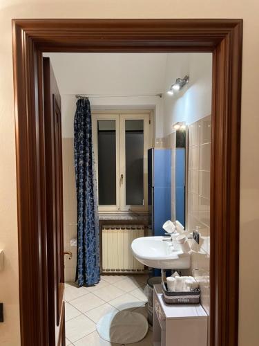 a bathroom with a sink and a toilet and a shower at Arco Antico in Alba