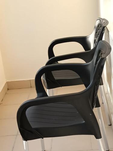 a black chair sitting in a room at Mkombodzi Global Homes in Mtwapa