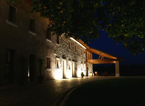 a building lit up at night with lights on it at Country House Due Fiumi in Sacile