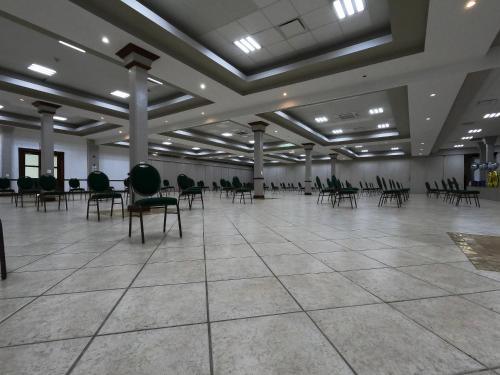 a large room with chairs and tables in it at Costa Bahia Hotel, Convention Center and Casino in Guayanilla