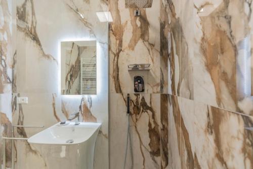 a bathroom with a sink and a mirror at Aldrovandi Luxury Suites and Apartment in Bologna
