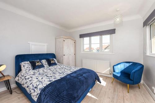 a bedroom with a blue bed and a blue chair at Merriesands, Middleton - On - Sea in Middleton-on-Sea