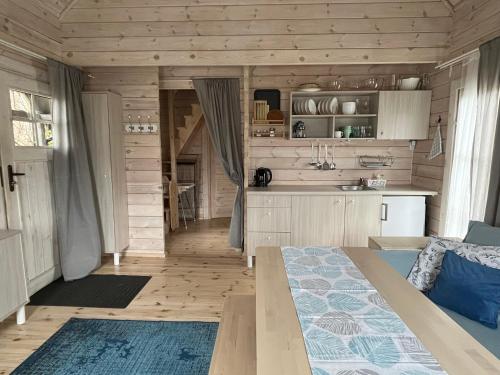 a kitchen and living room in a log cabin at Domki w Porcie Genaker in Giżycko