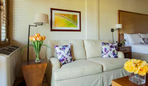 a living room with a couch and a bed at Copamarina Beach Resort & Spa in Guanica