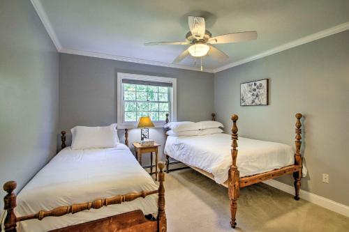 a bedroom with two beds and a ceiling fan at Readfield Retreat with Lake Maranacook Views! in Readfield
