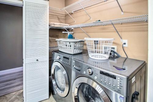 a washing machine in a laundry room with baskets on it at Readfield Retreat with Lake Maranacook Views! in Readfield
