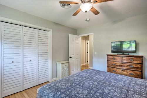 a bedroom with a blue bed and a ceiling fan at Clemson Getaway Less Than 3 Mi to Memorial Stadium! in Clemson