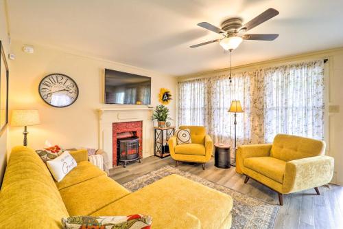 a living room with a yellow couch and a fireplace at Bright Boone Home Walk to Appalachian State! in Boone