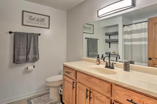 a bathroom with a sink and a toilet and a mirror at Berryville Home Near Wineries Mountain Views in Berryville