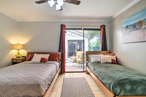 a bedroom with two beds and a door to a patio at Pool, Grill and Game Room Bermuda Dunes Oasis in Bermuda Dunes