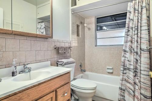 a bathroom with a sink and a toilet and a window at San Antonio Home with Yard, 7 Mi to SeaWorld! in San Antonio