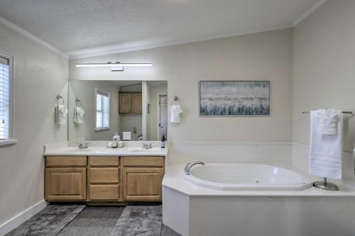 a white bathroom with a tub and a sink at Lovely Lehi Retreat 27 Mi to Alta Ski Area! in Lehi