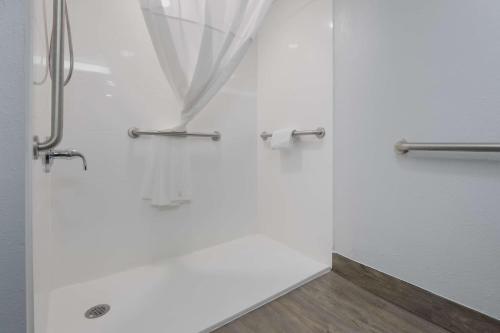 a shower with a glass door with a curtain at SureStay Plus Hotel by Best Western Gatlinburg in Gatlinburg