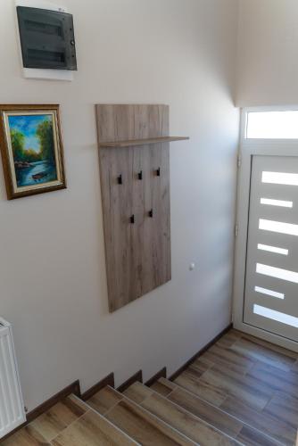 a stairway with a white wall and a door at JEDRO - Apartman sa garažnim parkingom in Vrnjačka Banja