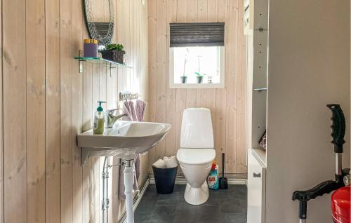 a bathroom with a toilet and a sink at 5 Bedroom Stunning Home In Mellbystrand in Mellbystrand