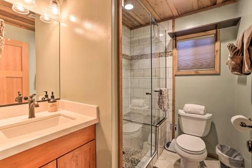 a bathroom with a shower and a toilet and a sink at Peaceful Big Bear Cabin Walk to Lake Access! in Big Bear Lake