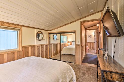 a bedroom with a bed and a tv in it at Peaceful Big Bear Cabin Walk to Lake Access! in Big Bear Lake