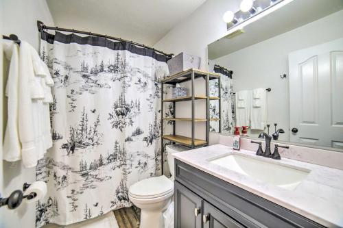 a bathroom with a sink and a toilet and a shower curtain at Idaho Falls Townhome about 5 Mi to Tauthaus Park! in Idaho Falls