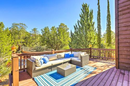 a porch with a couch and a table on a deck at Mountain-View Deck Bright Sedona Home in Sedona