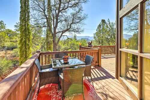 a wooden deck with a table and chairs on it at Mountain-View Deck Bright Sedona Home in Sedona