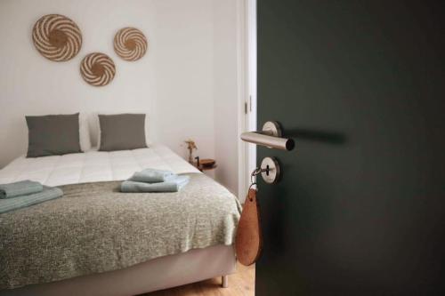 a bedroom with a bed next to a door at Casa da Mostardeira in Évora